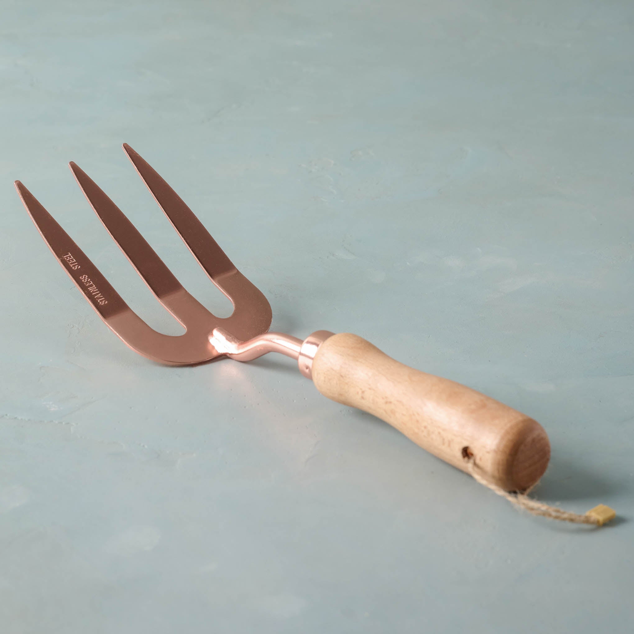 Copper garden fork with wooden handle