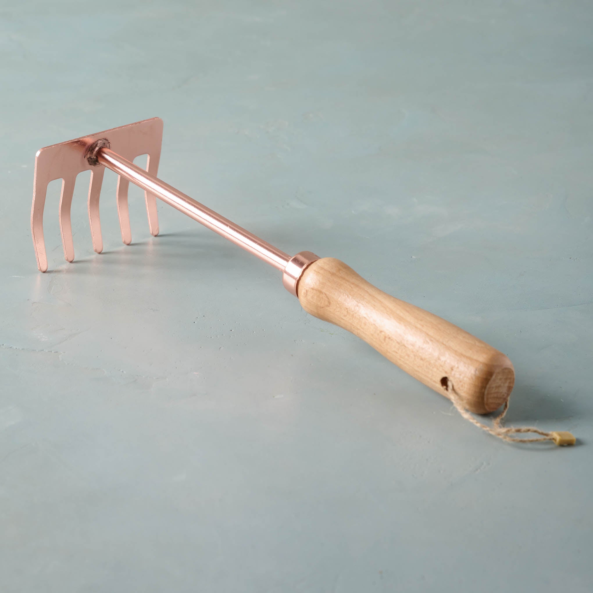 Copper rake with wooden handle On sale for $9.60, discounted from $16.00