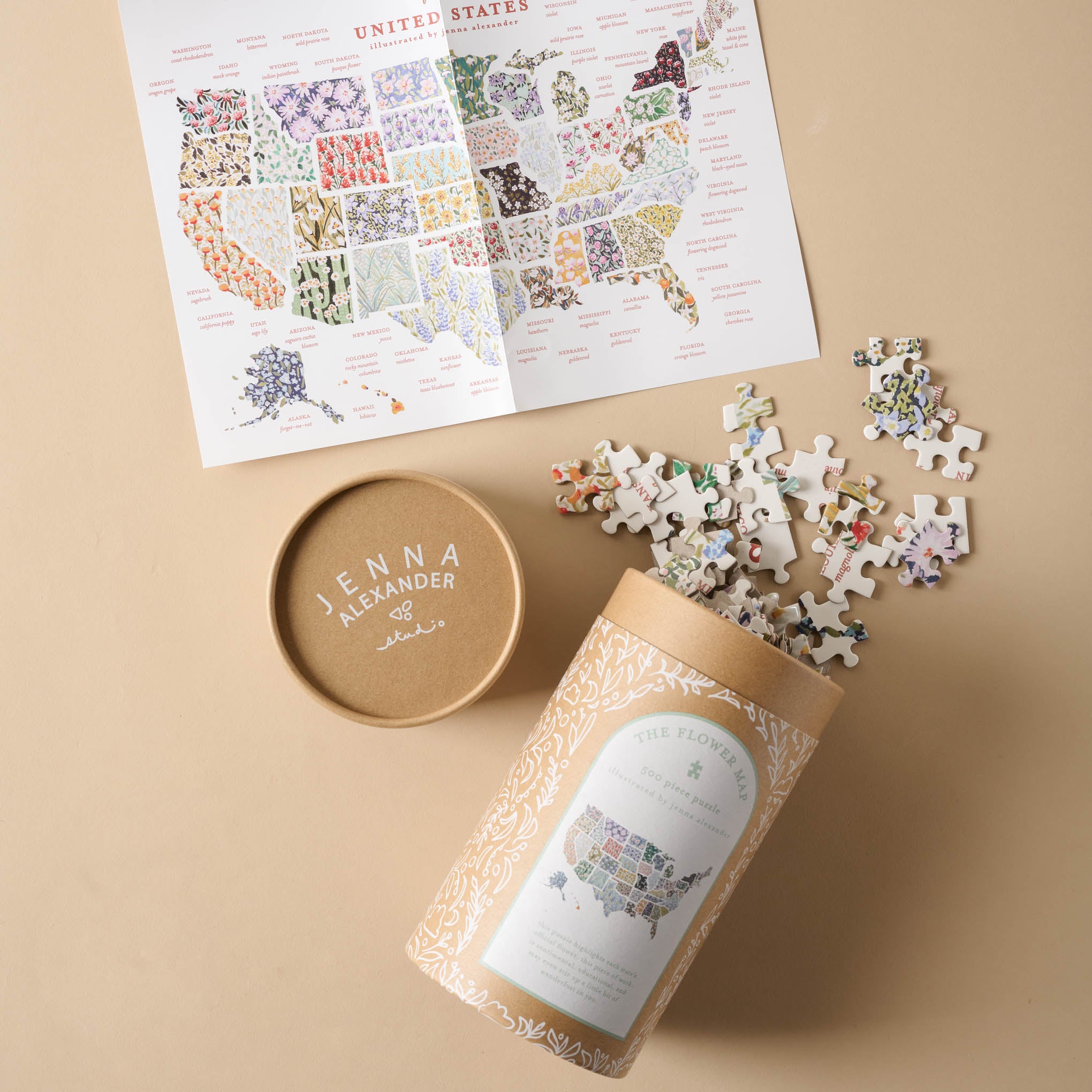 Flower Map of the USA Puzzle pieces spilling out of cylinder container and a picture of the finished puzzle $38.00