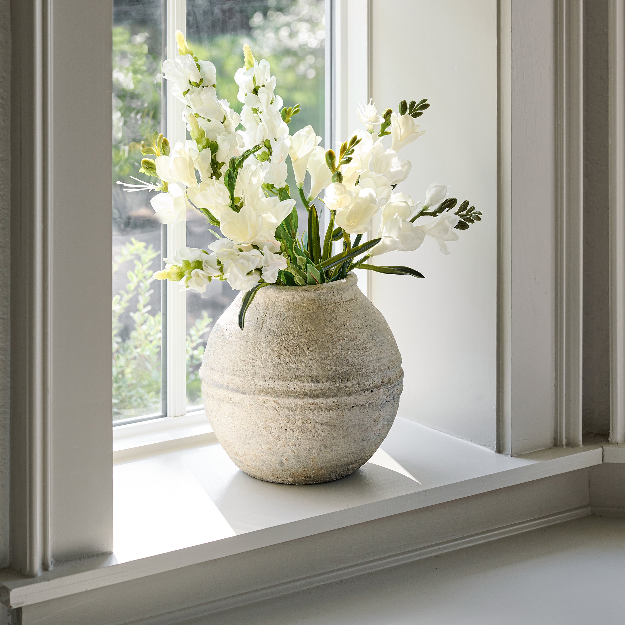 Concrete Round Vase with florals on window sill $58.00