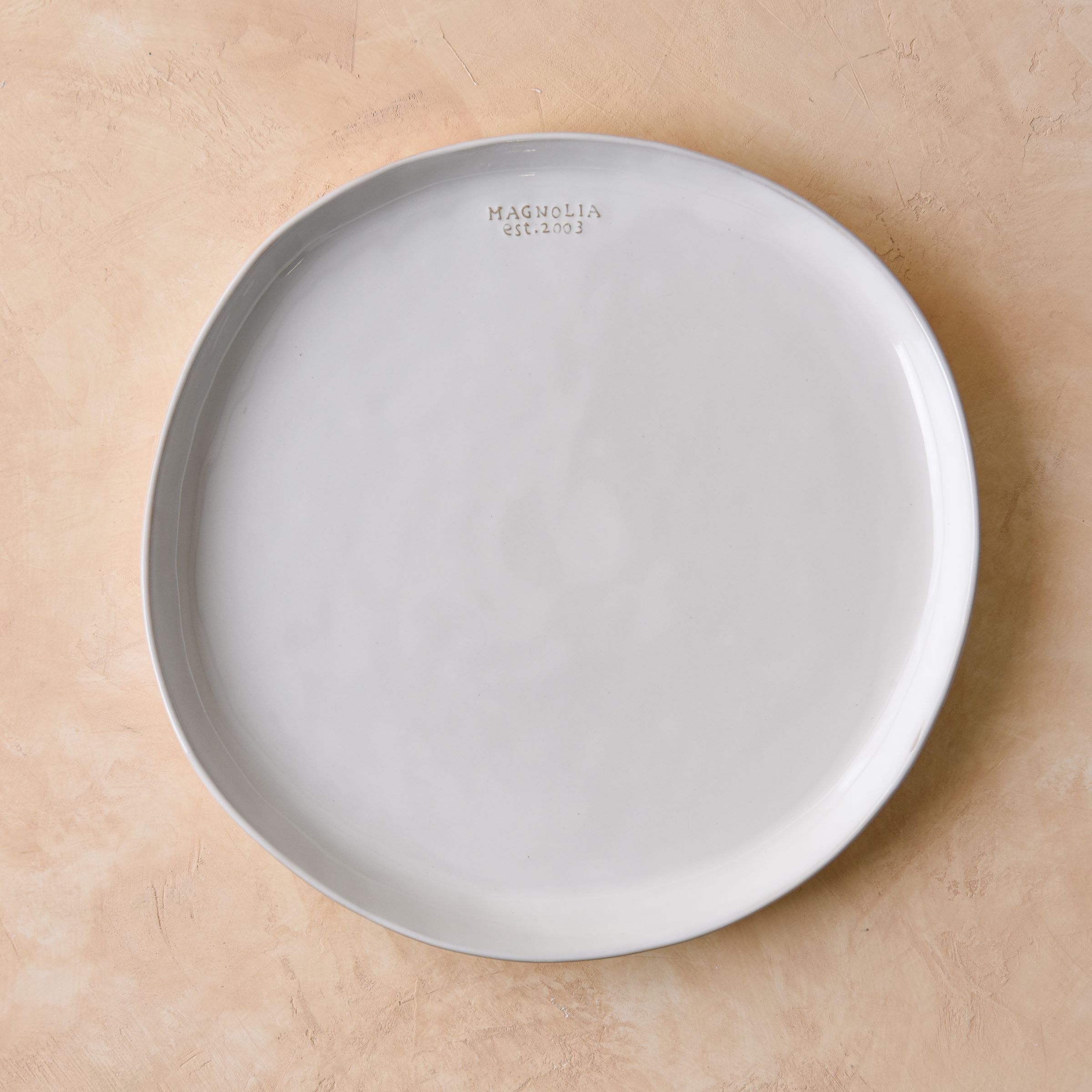 round ceramic serving platter embossed with magnolia est 2003 On sale with items ranging from $22.40 to $30.40, discounted from $28.00 to $38.00