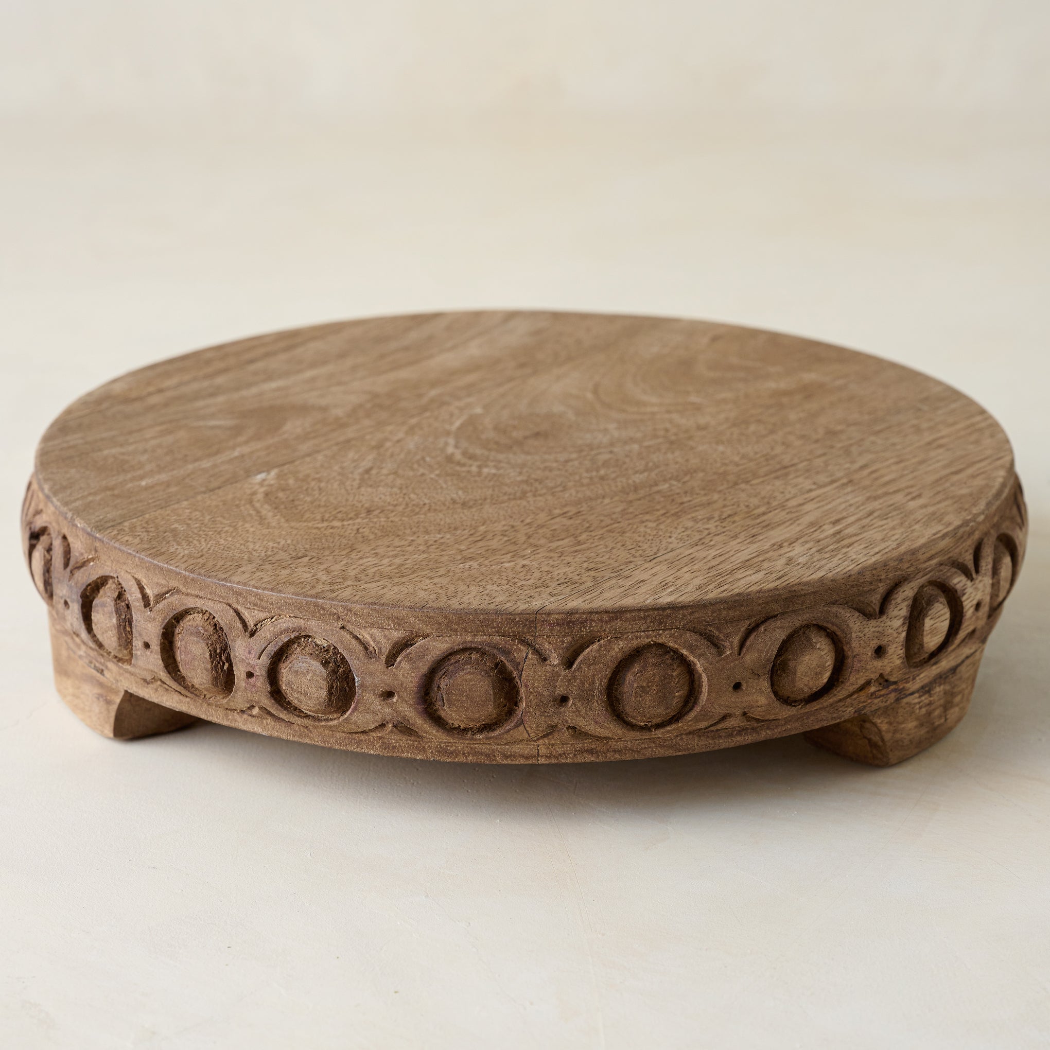 Antiqued Carved Wood Round Riser shown at a higher angle $42.00