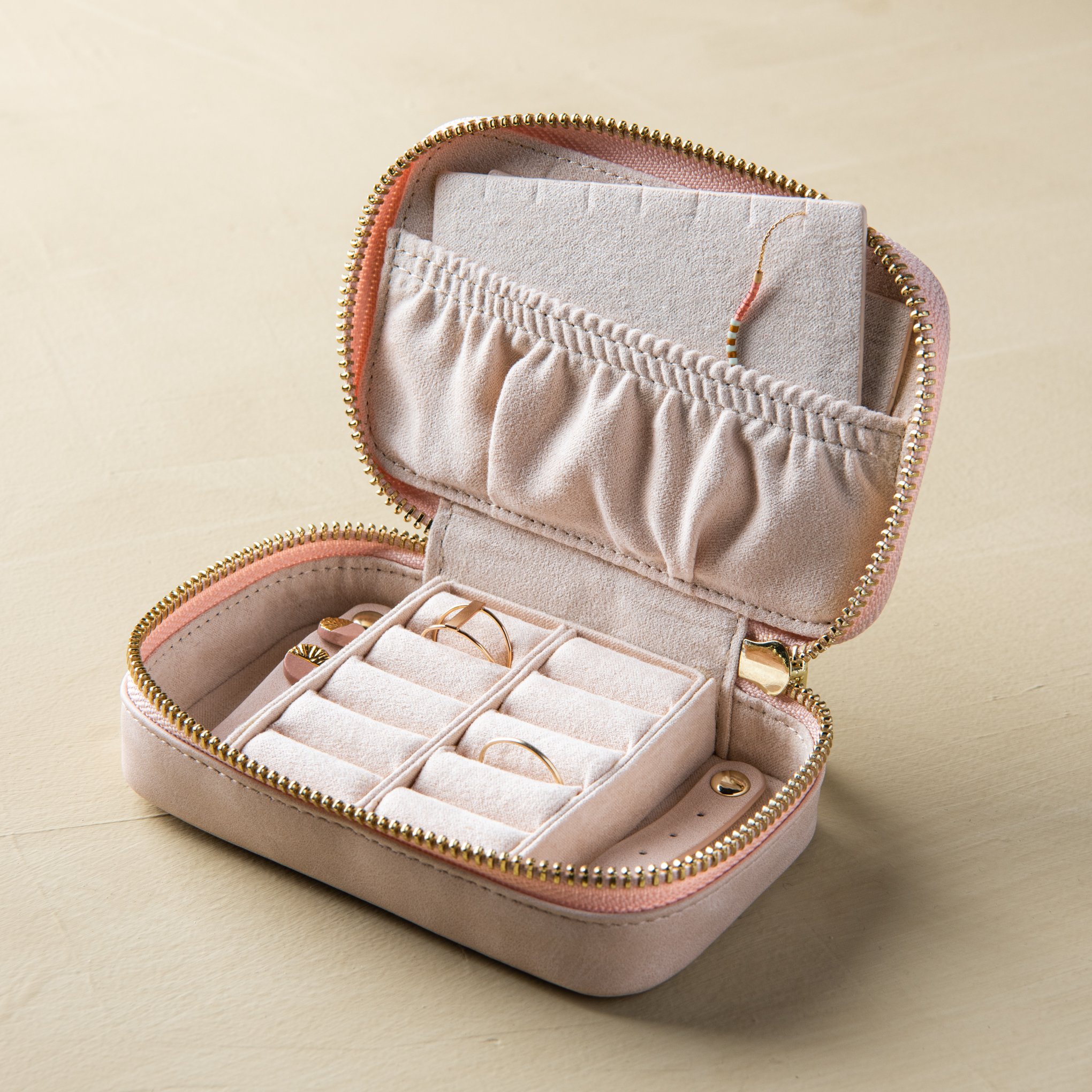 small pink zip-up portable jewelry case