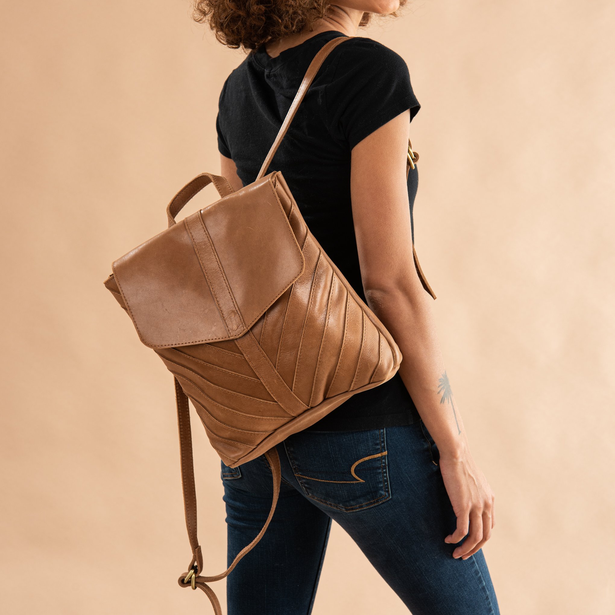 brown leather backpack with herringbone pattern stitching