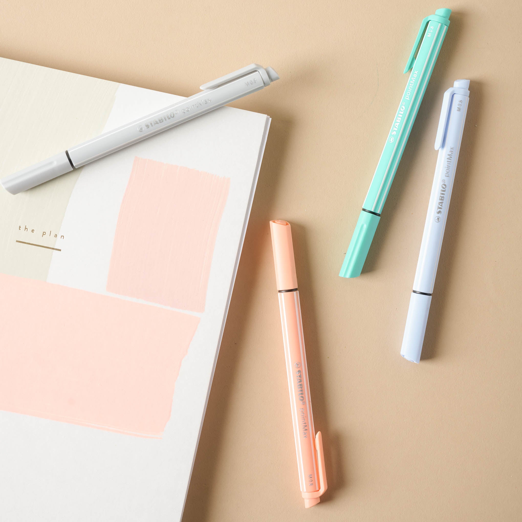 Set of 4 Stabilo Pens shown with melon weekly planner