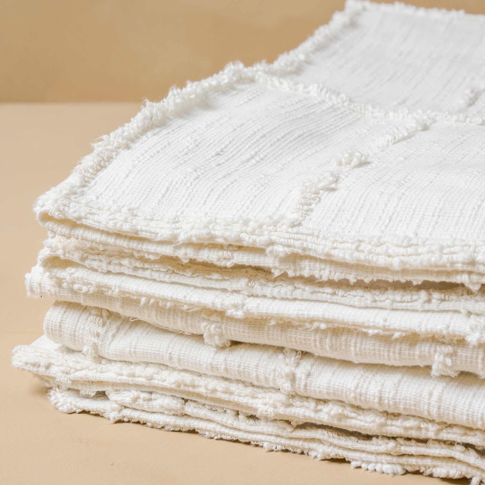 Close up of folded Optic White Textured Cotton Coverlet