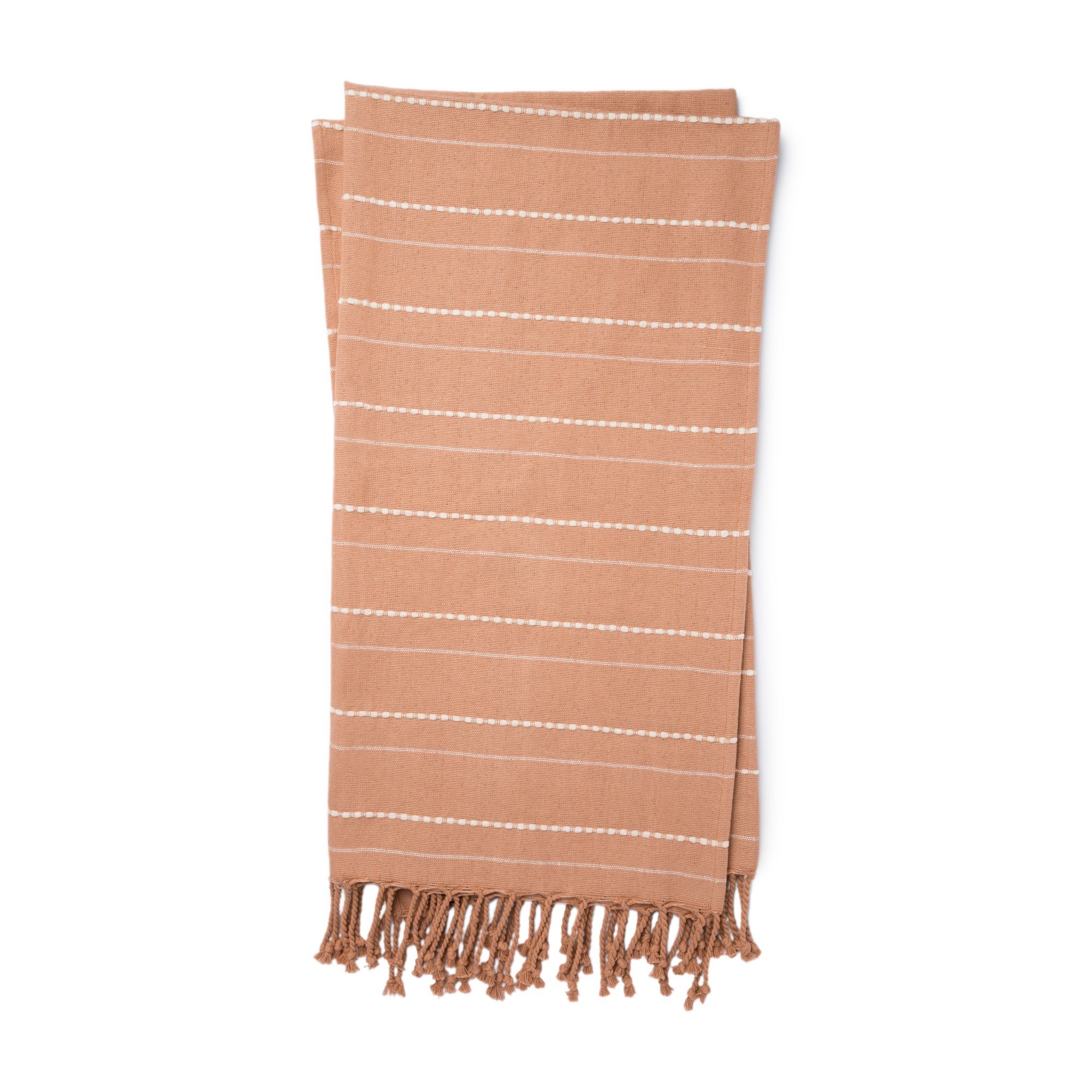 blush colored throw with white pin stripes and blush tassel fringe