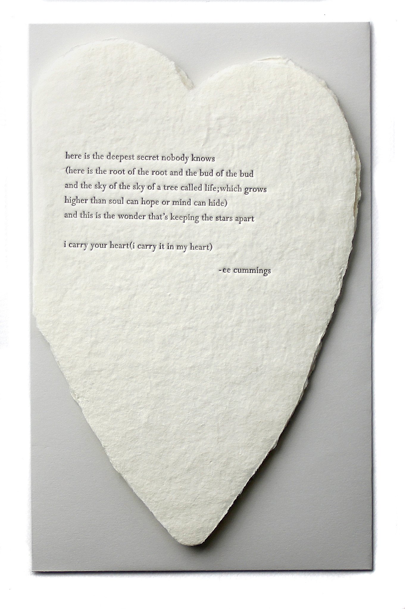 deckled paper heart with quote from ee cummings embossed