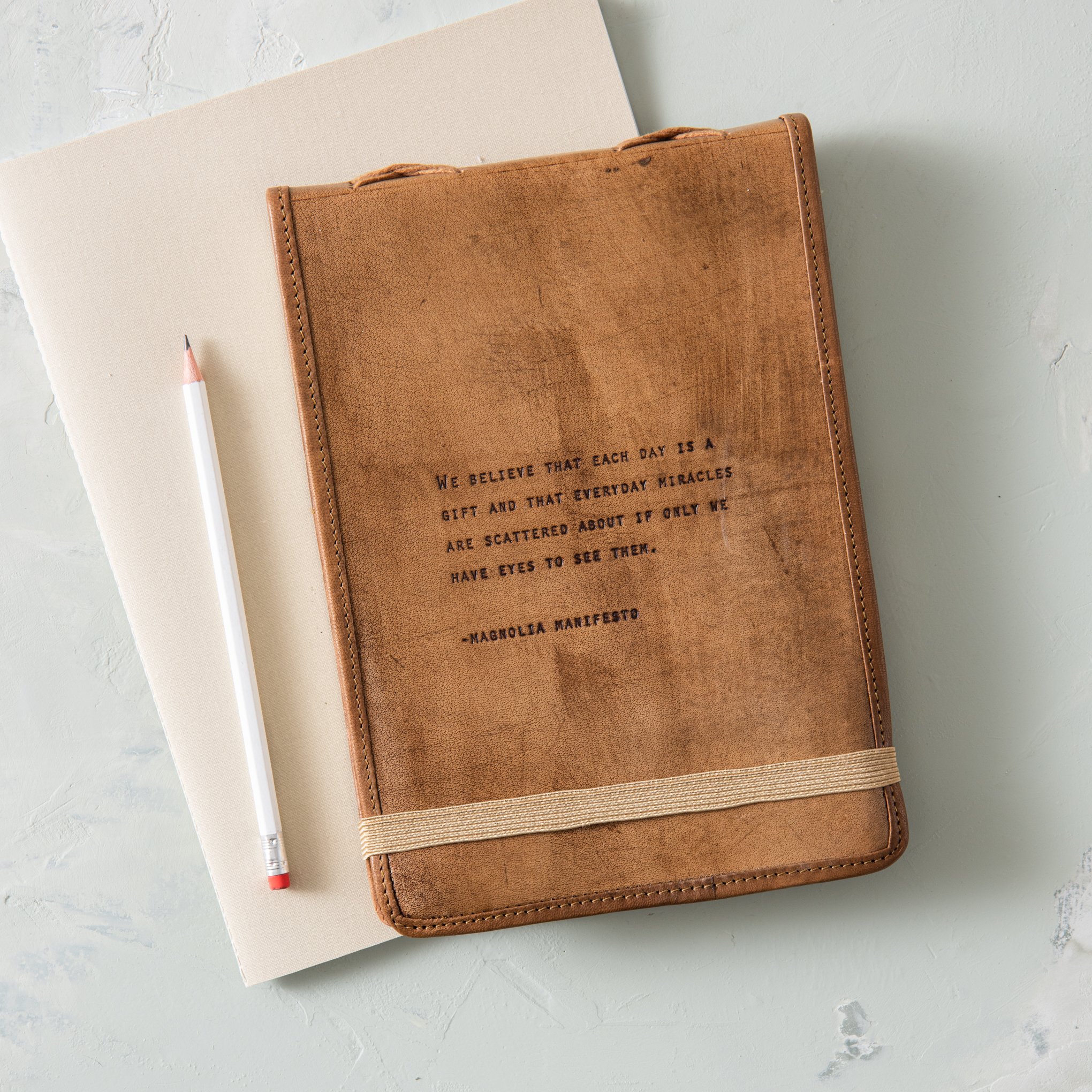 leather journal with excerpt from magnolia manifesto embossed on the cover On sale for $38.40, discounted from $48.00