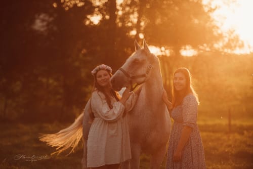 /_vercel/image?url=/Sisters+with+horse+in+summer+sunset.&w=1536&q=100