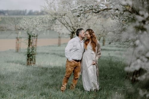 /_vercel/image?url=/Couple+is+walking+through+the+blossoming+appletrees.&w=1536&q=100