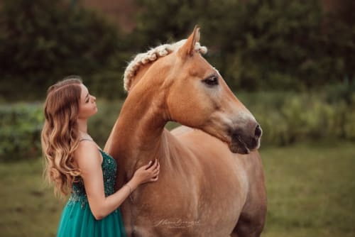 /_vercel/image?url=/Woman+with+dress+looking+at+her+horse+in+the+nature.&w=1536&q=100