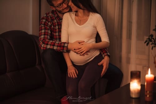 /_vercel/image?url=/Pregnant+woman+sitting+on+her+husband,&w=1536&q=100