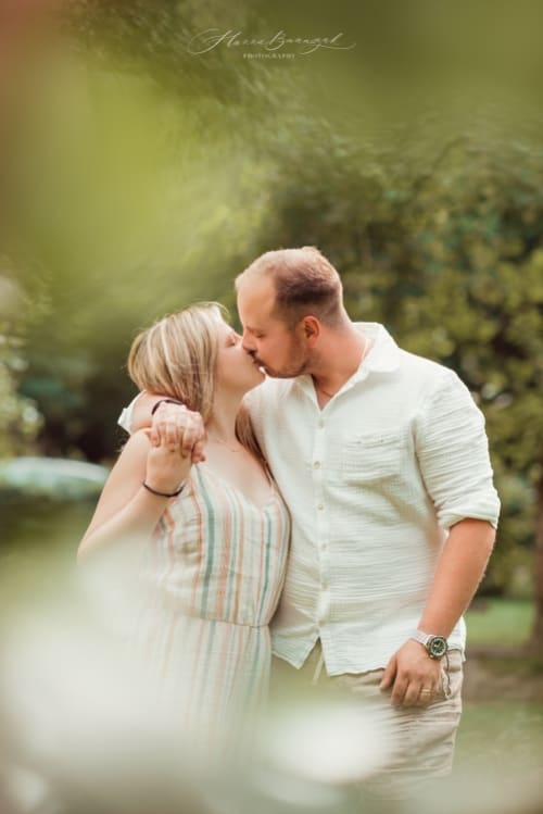 /_vercel/image?url=/Married+couple+is+kissing+behind+the+tree+during+sunny+day.&w=1536&q=100