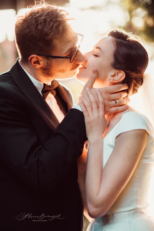 /_vercel/image?url=/Groom+kisses+the+bride+during+the+sunset+photoshoot.&w=1536&q=100