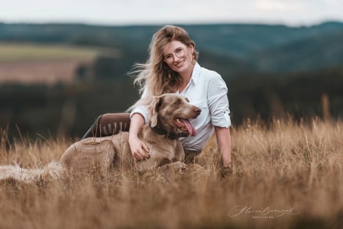 /_vercel/image?url=/Girl+with+her+dog+are+sitting+on+the+field+during+the+summer+sunset.&w=1536&q=100