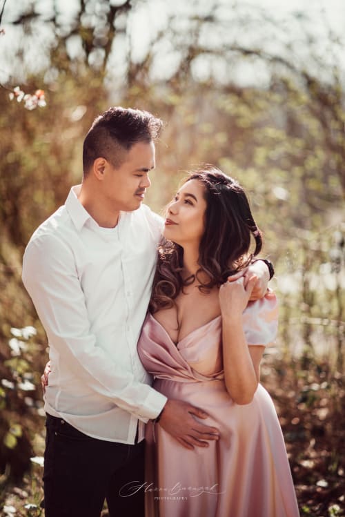 /_vercel/image?url=/Pregnant+girl+in+pink+dress+is+hugged+by+her+husband.&w=1536&q=100