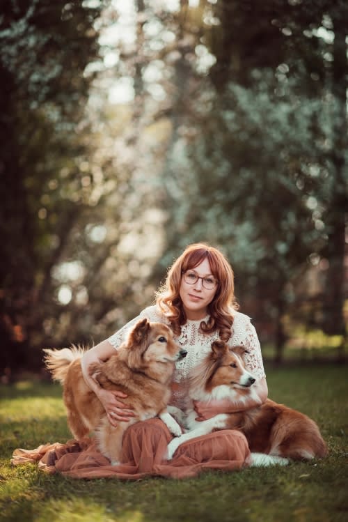 /_vercel/image?url=/Woman+is+sitting+on+the+grass+with+her+two+rescue+dogs+during+the+sunset+light.&w=1536&q=100