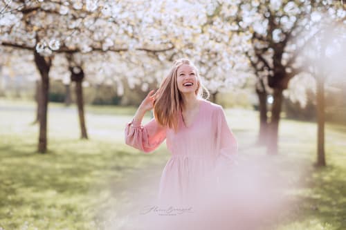 /_vercel/image?url=/Girl+in+pink+dress+is+walking+through+the+blossoming+trees+area.&w=1536&q=100