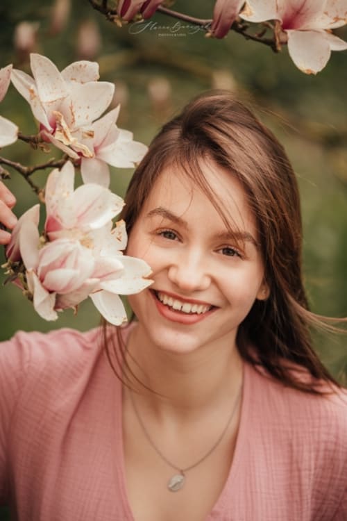 /_vercel/image?url=/Potrait+of+woman+next+to+magnolia.&w=1536&q=100