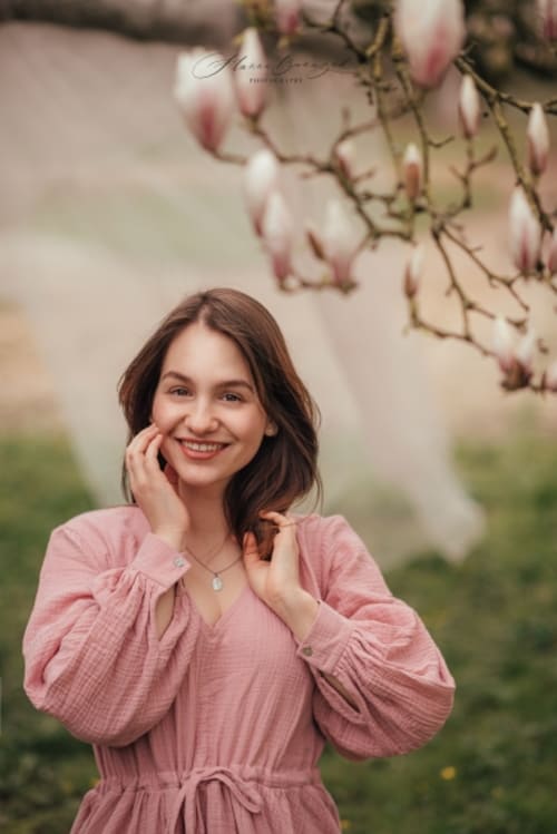 /_vercel/image?url=/Portrait+of+woman+with+blooming+magnolia.&w=1536&q=100