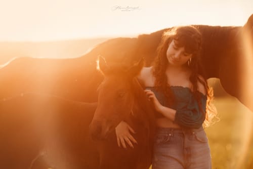 /_vercel/image?url=/Girl+hugging+a+foal.&w=1536&q=100