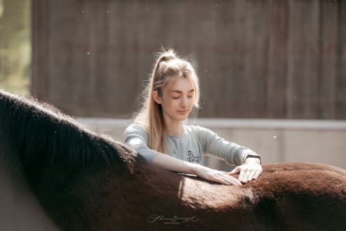 /_vercel/image?url=/Girl+giving+a+therapeutic+massage+to+a+horse.&w=1536&q=100