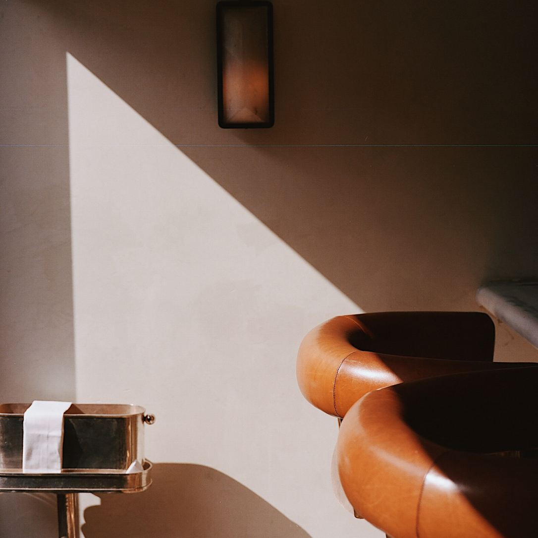 Two orange high chairs in a bar.