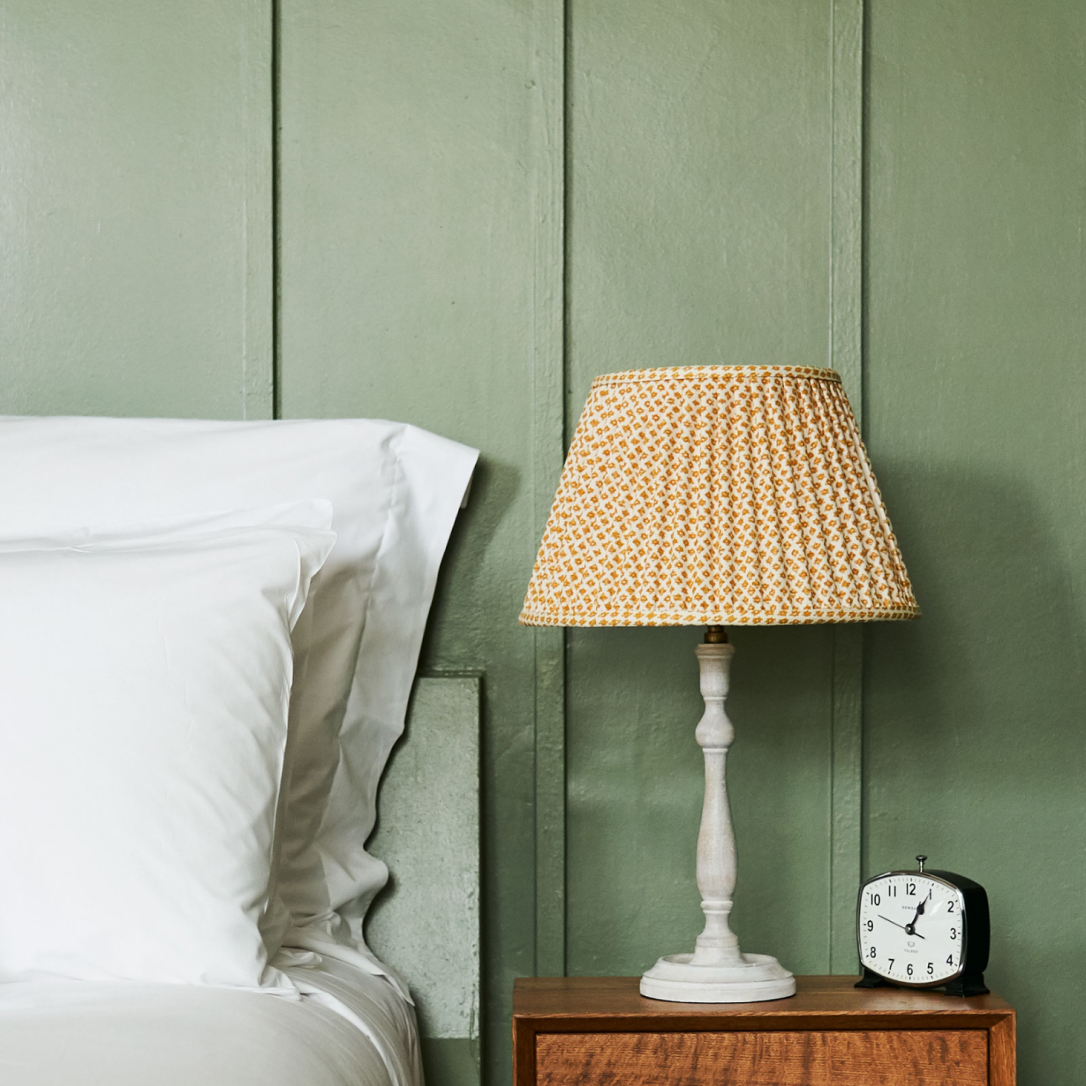 A detail of a bed and bed side cabinet.