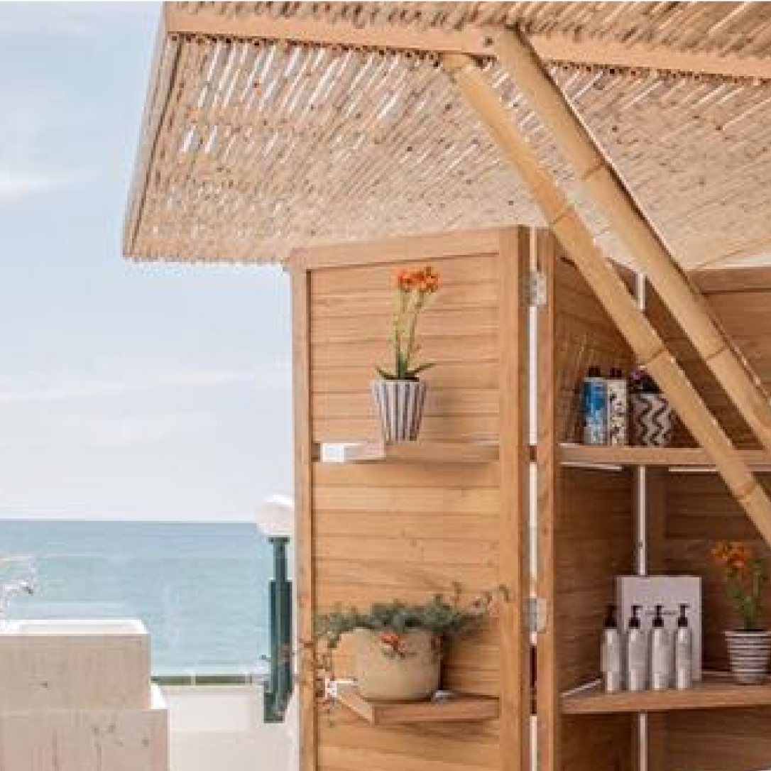 A wooden enclosure with beauty products and plants.