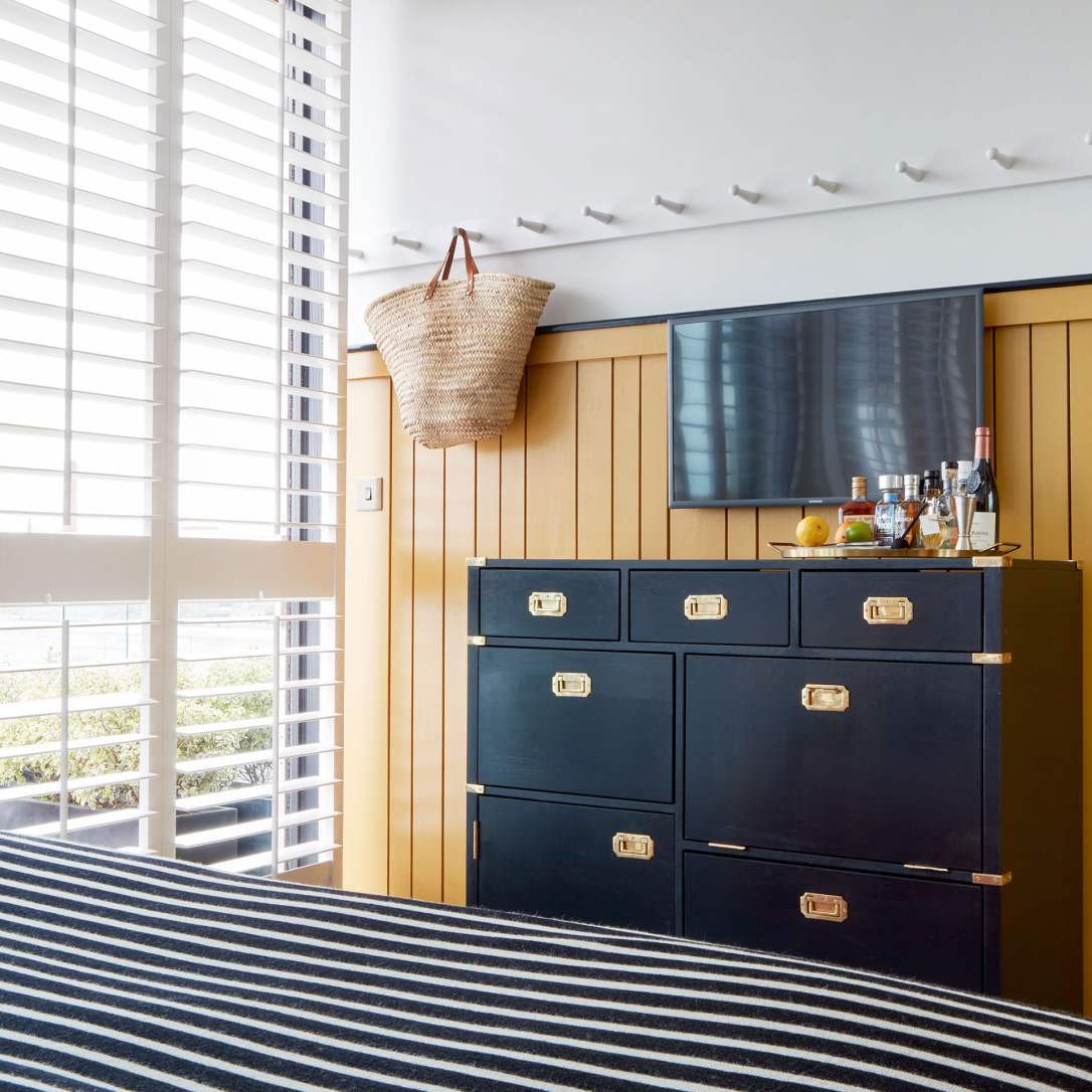 A storage unit in a yellow bedroom.