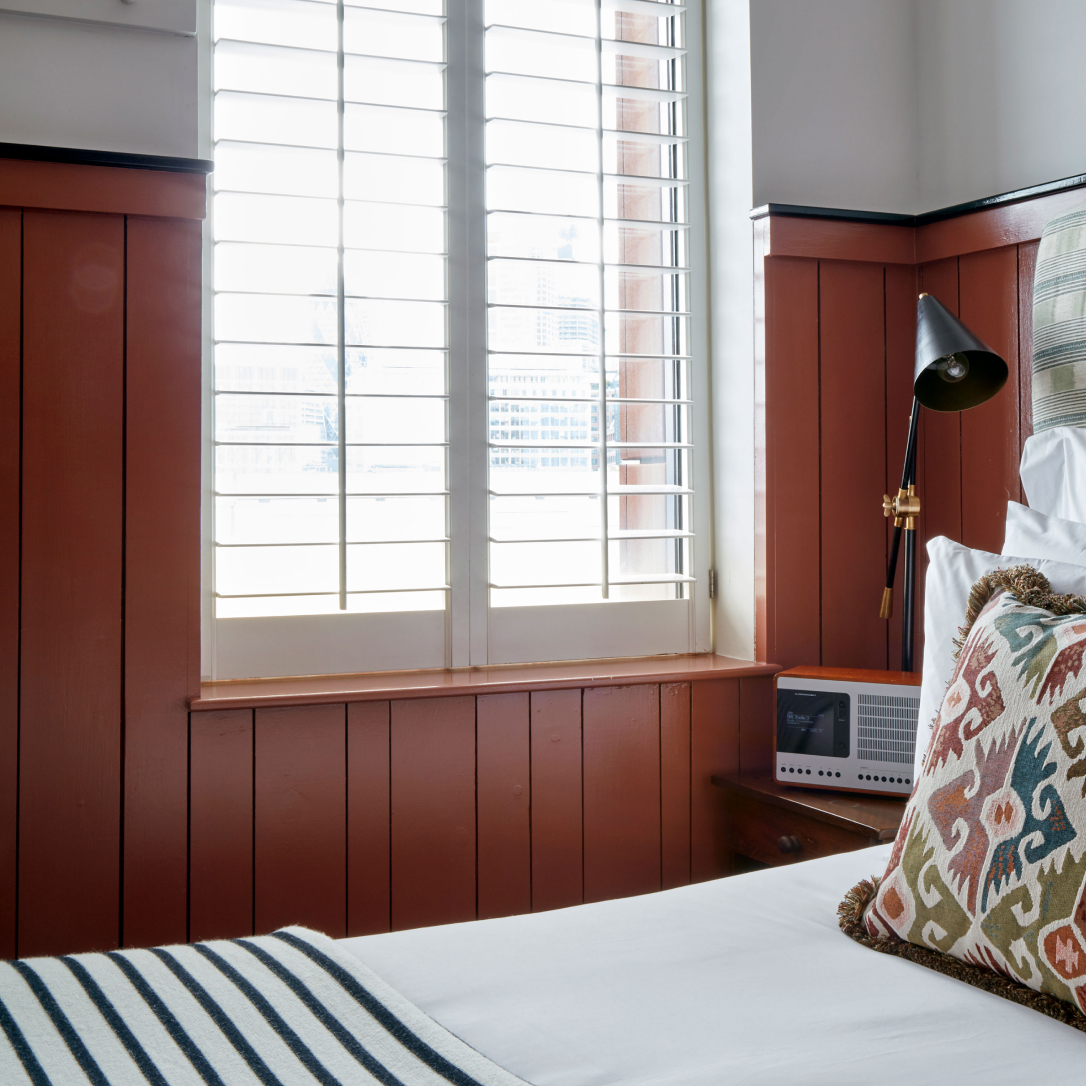 The corner of a red bedroom.