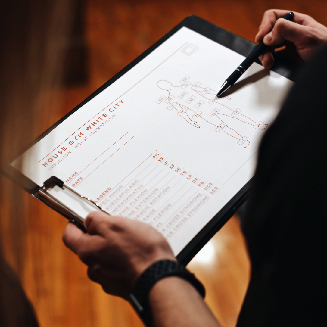 A man checks a list on a workout planner.