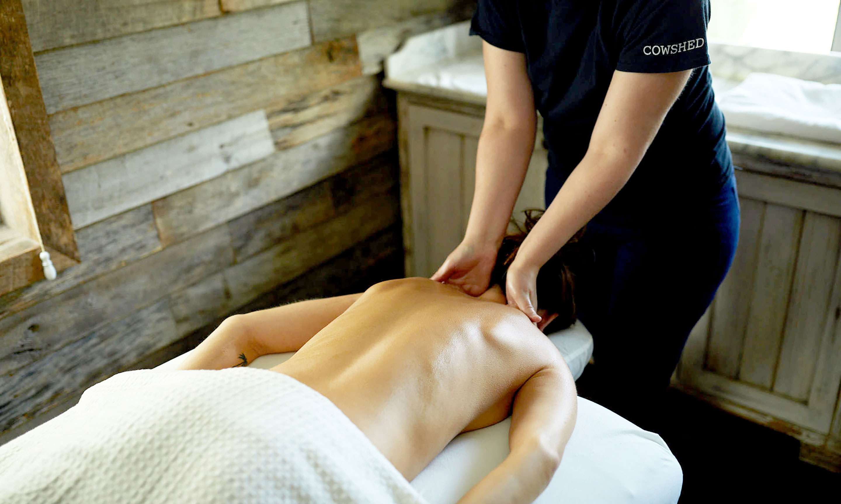 A woman receiving a massage in a spa.