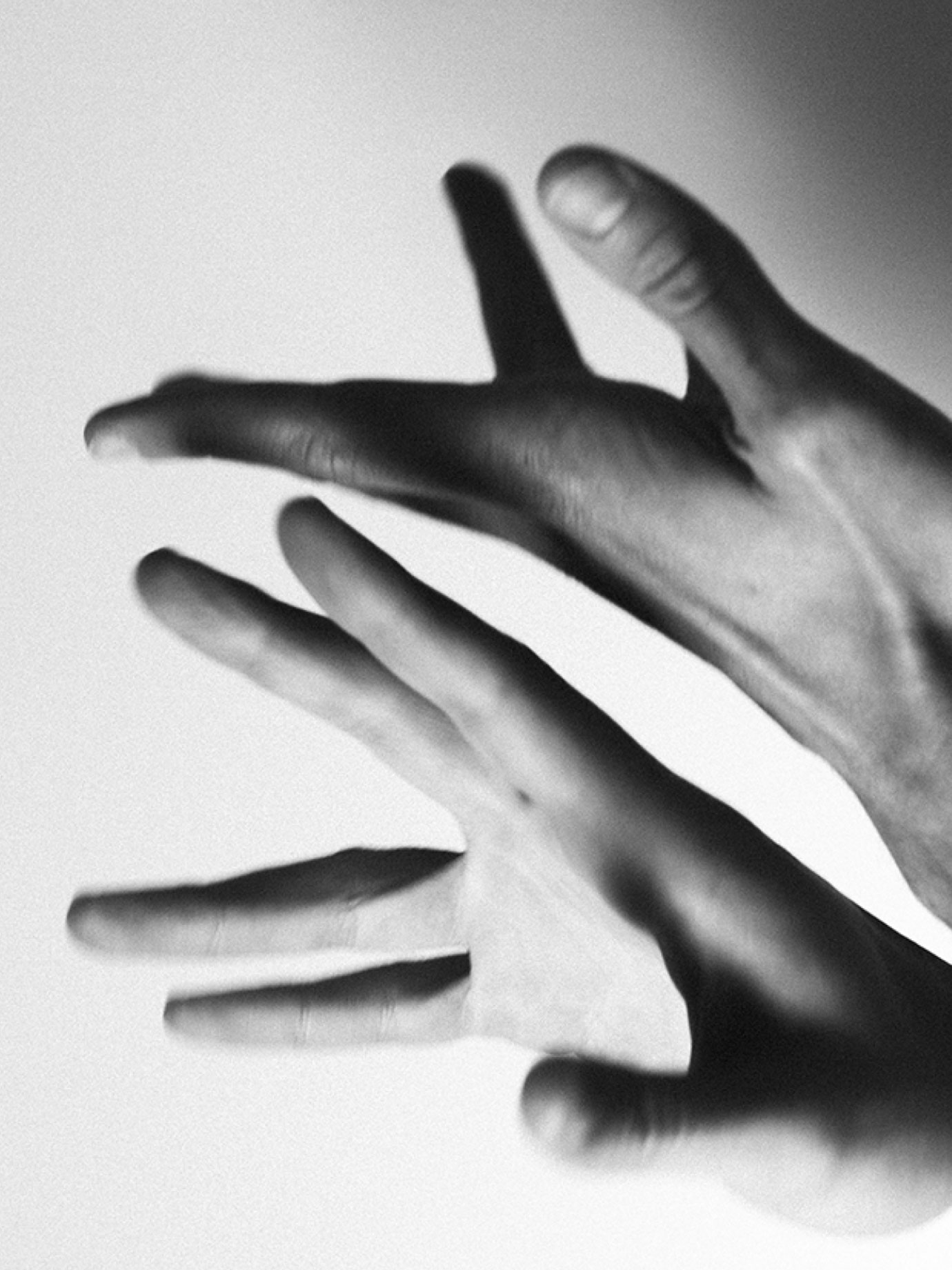 Black and white hands gesticulating.