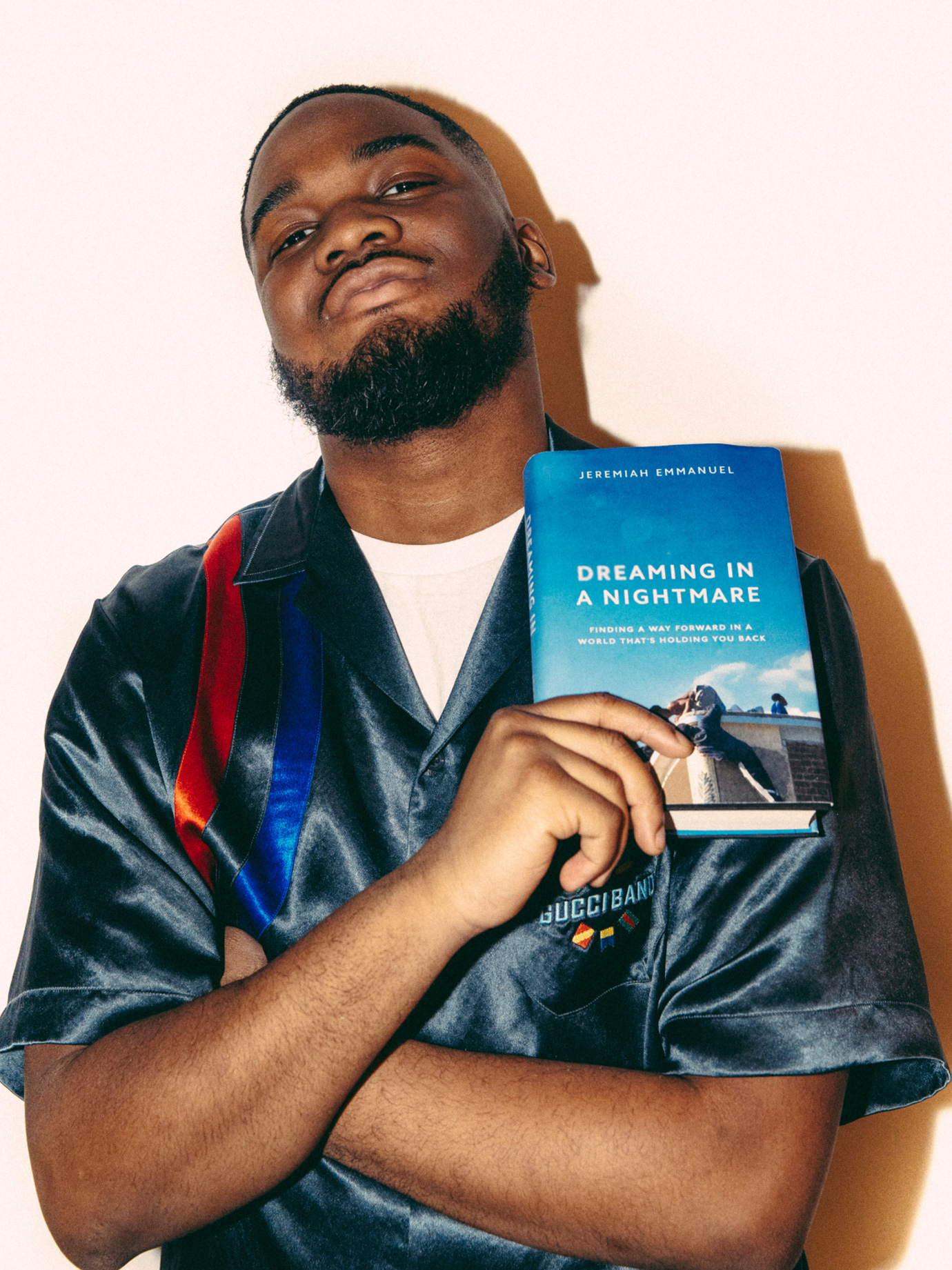 A man holding a book up to his chest.