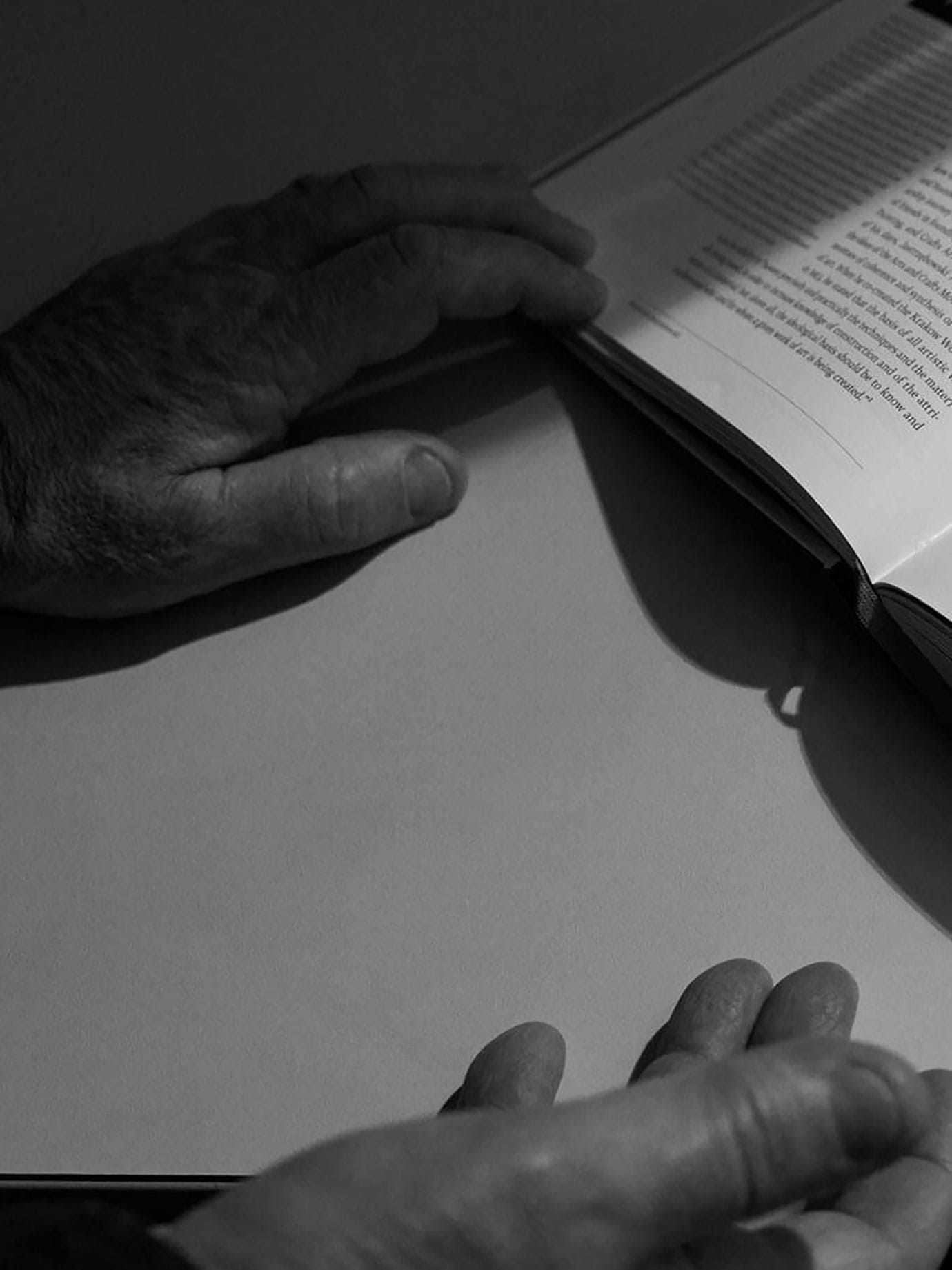 Two hands holding a book.