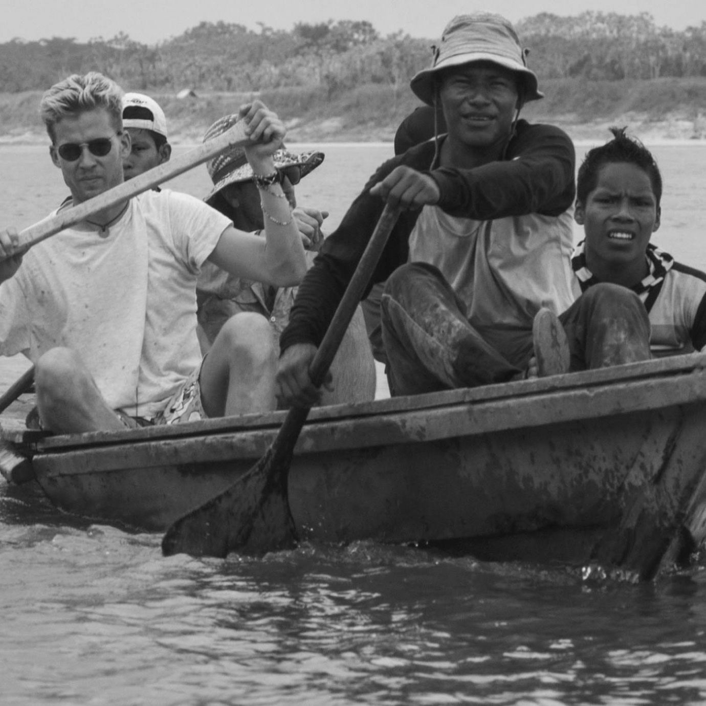 A group of men rowing on a river.