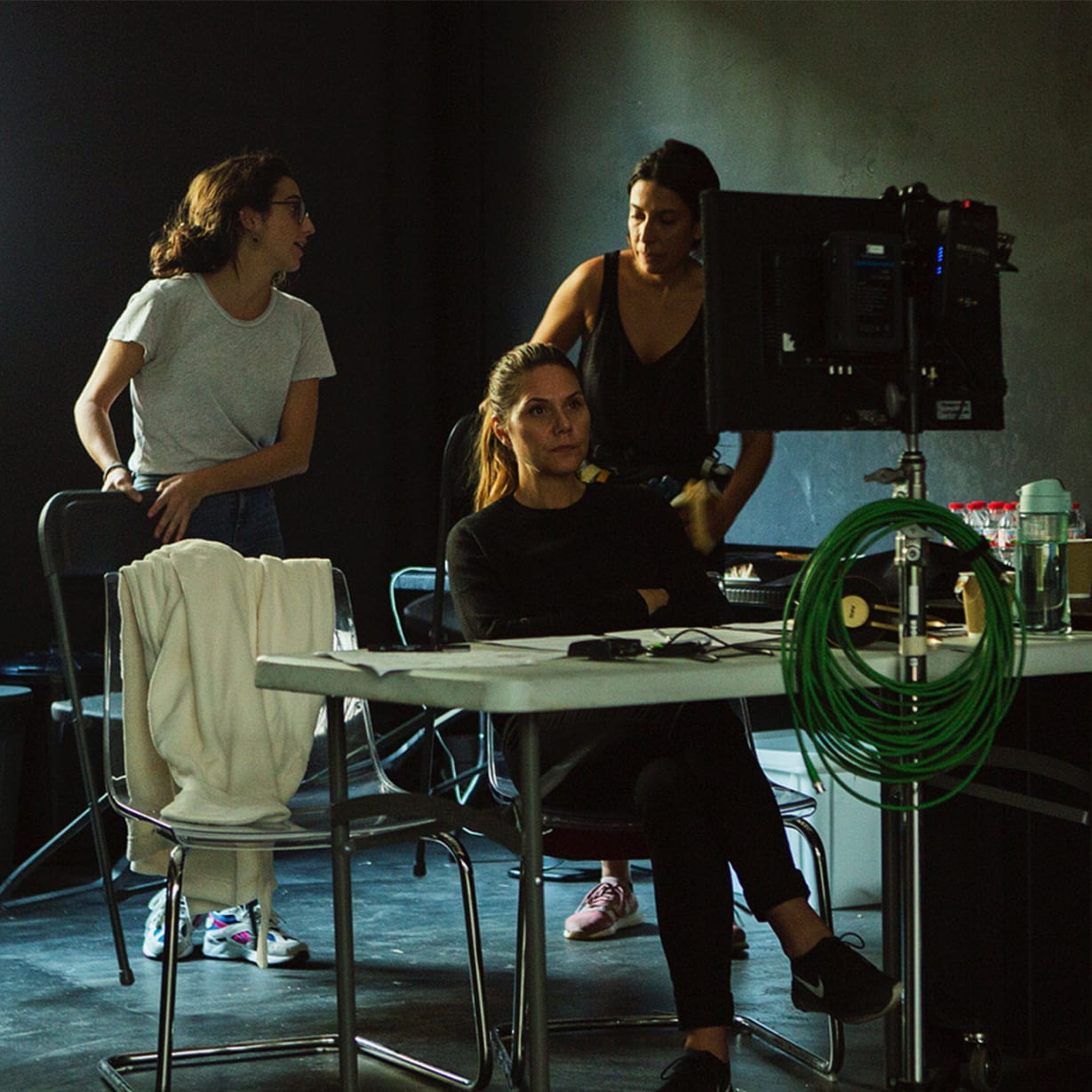 group of women behind directing table with camera equipment