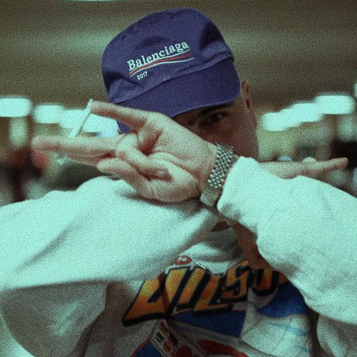 man in sweatshirt and cap in parking lot