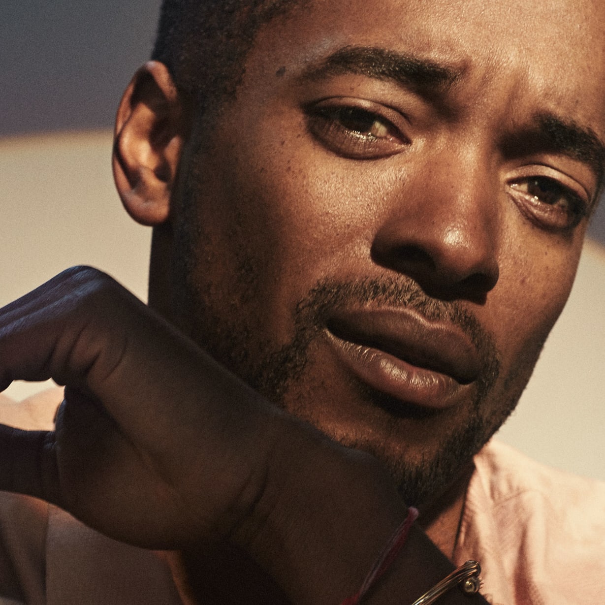 A close up of a man with a white circle of light behind him.