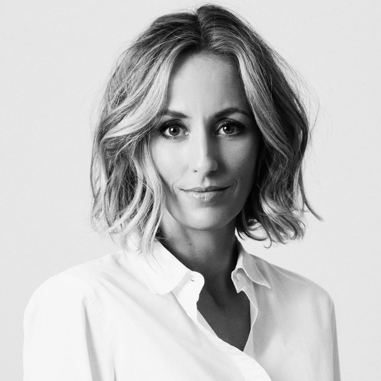 A blonde woman in a white shirt.