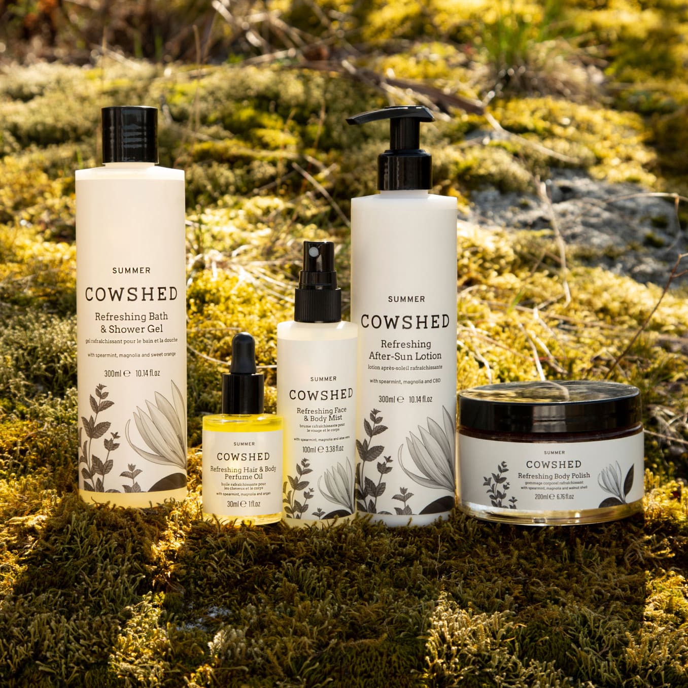 five cowshed beauty products on a mossy rock
