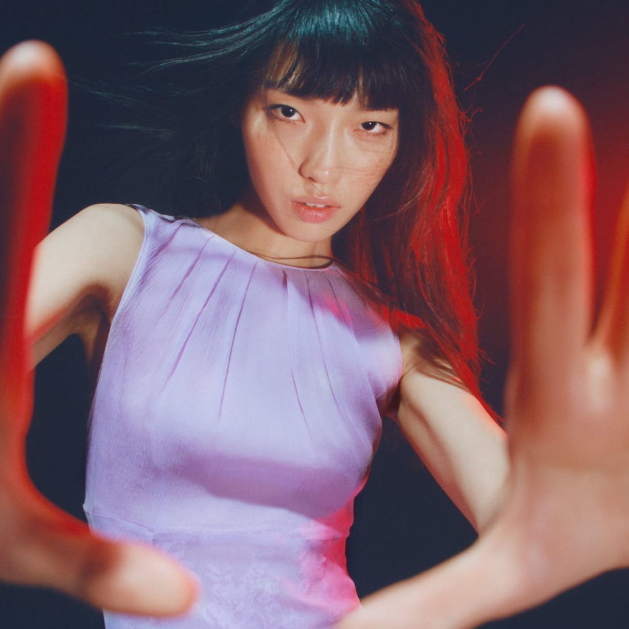 A woman with her hands out towards the camera.