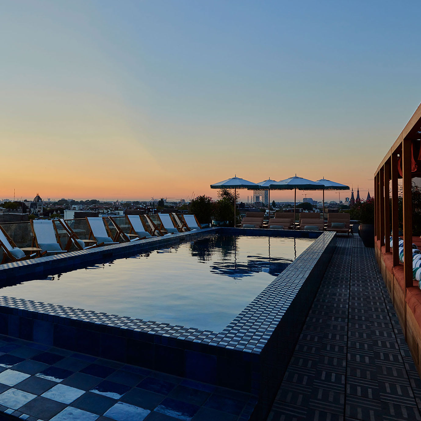 A rooftop pool at sunset.