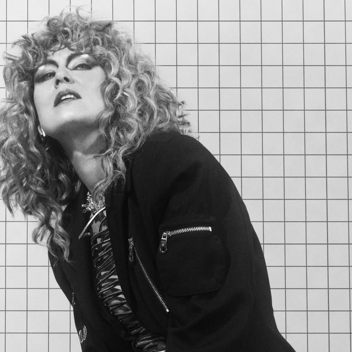 A woman with a perm wearing black.