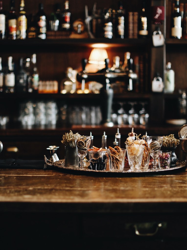 A bar with cocktail garnishes in glasses on it.