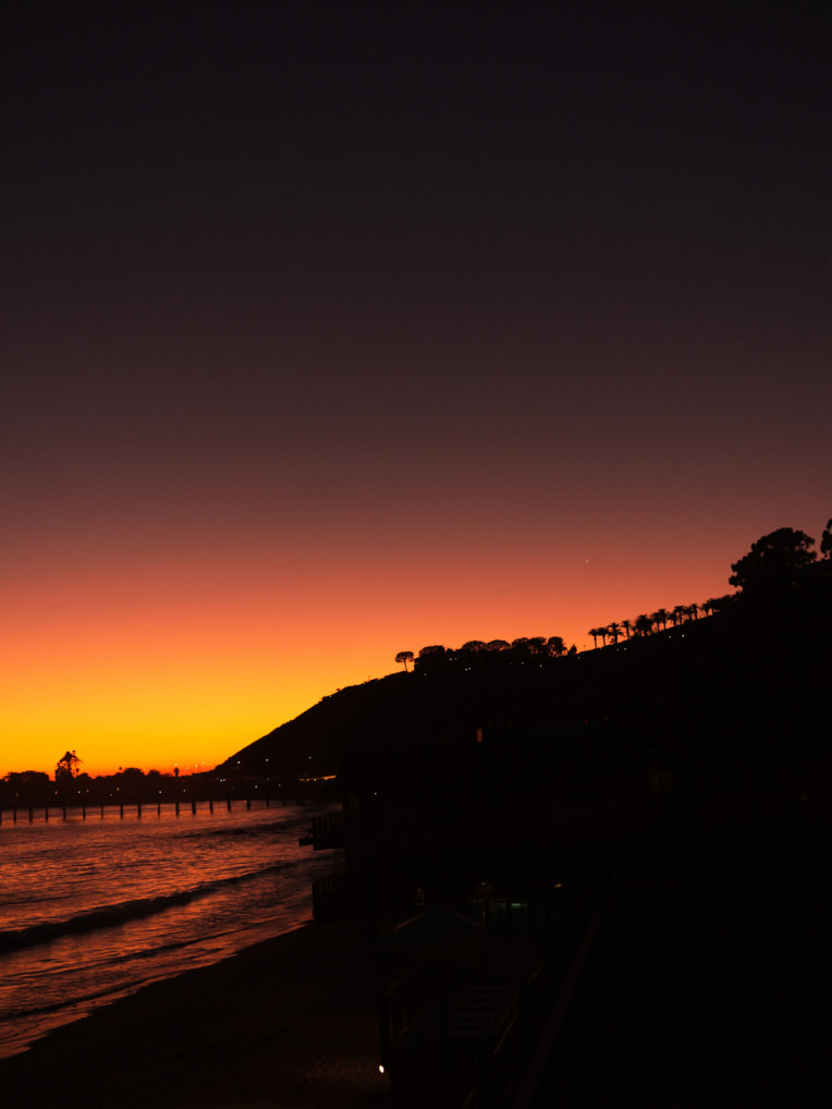 A beach and hill at night.