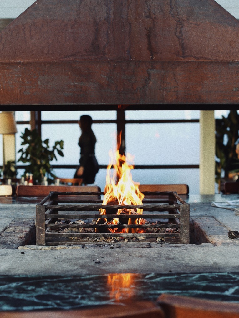 An open fire and grill in a restaurant.