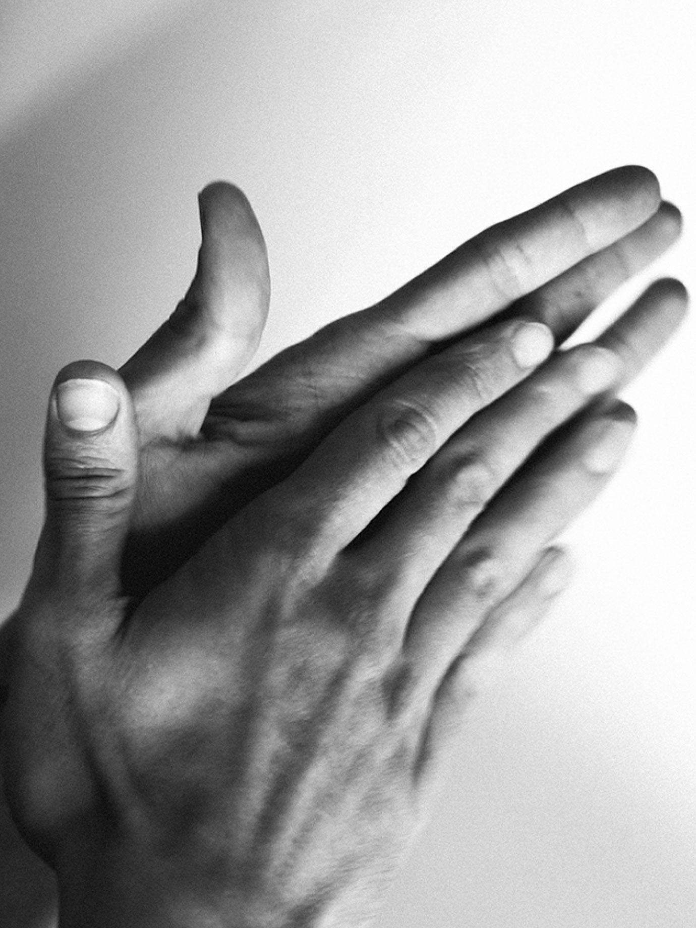 Black and white hands gesticulating.